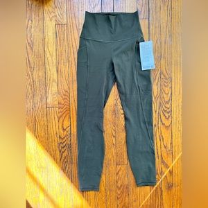 Dark green Lulu Lemon 25” leggings with pockets
